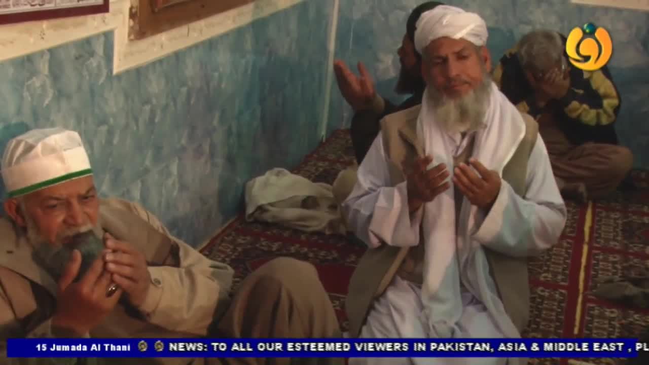 Several men, all with white beards and head coverings, are seated on the floor, some with their hands raised. The Noor TV logo is visible in the corner, and a news ticker at the bottom addresses viewers in Pakistan, Asia, and the Middle East.
