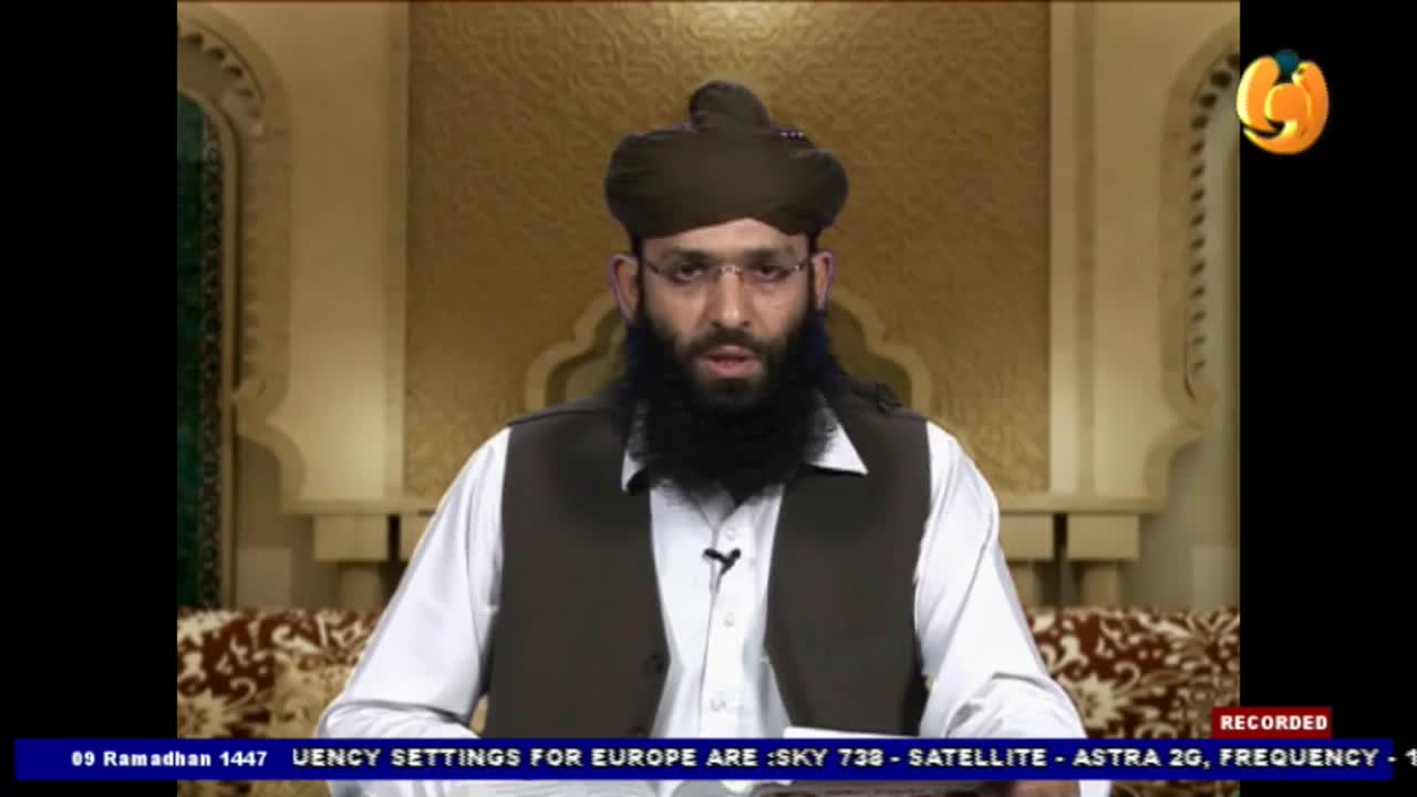 A man with a long beard and a dark turban speaks directly to the camera, wearing a white shirt and a dark vest. The Noor TV logo is visible in the upper right corner. A man with a long beard and a dark turban speaks directly to the camera, wearing a white shirt and a dark vest. The Noor TV logo is visible in the upper right corner.