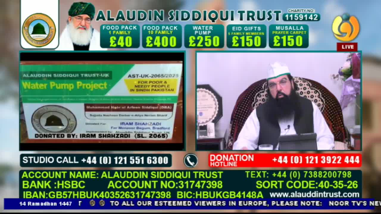 A man in a white cap and beard speaks from a chair while a screen behind him displays a "Water Pump Project" for Sindh, Pakistan. The Alaudin Siddiqui Trust is soliciting donations, with prices listed for food packs and Eid gifts.