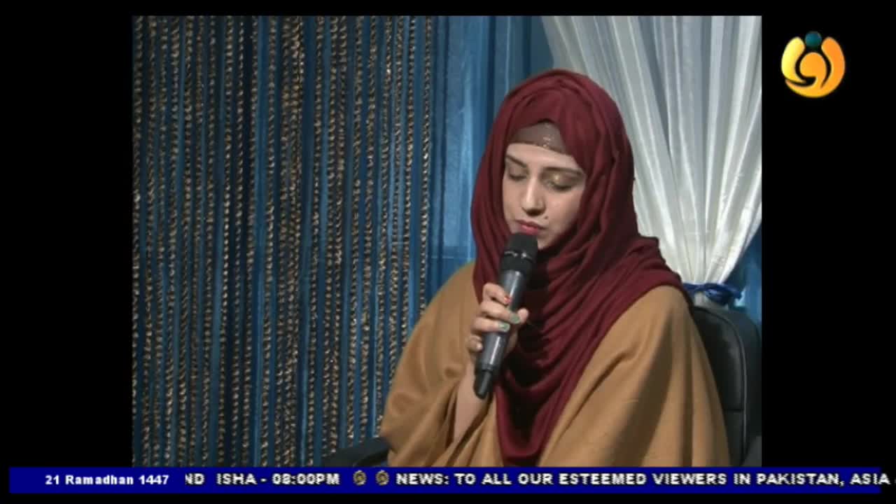 A woman in a maroon hijab speaks into a microphone, her voice broadcast by Noor TV. The screen displays the date 21 Ramadhan 1447, indicating a broadcast from the UK.