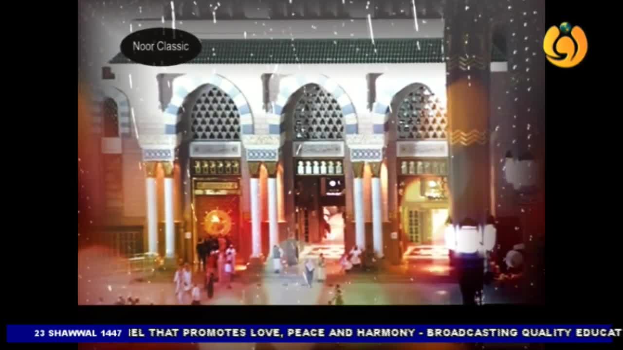 People are walking through arched doorways of a building, illuminated by warm lights. A graphic overlay from Noor TV, a UK-based channel, reads "Noor Classic" above the scene. People are walking through arched doorways of a building, illuminated by warm lights. A graphic overlay from Noor TV, a UK-based channel, reads "Noor Classic" above the scene.