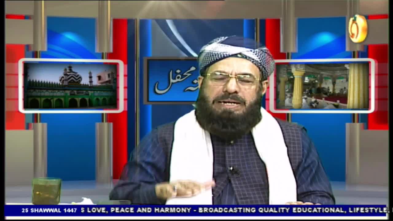 A man in a turban speaks animatedly, his hands gesturing. On screens behind him, images of mosques appear.