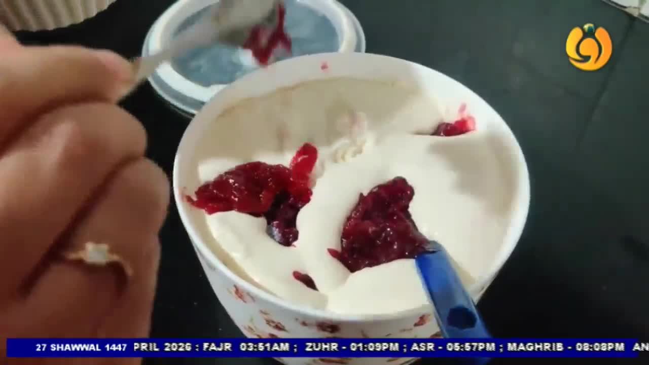 A spoon is adding dollops of red jam to a bowl of creamy white dessert, likely ice cream. The Noor TV logo is visible in the upper right corner.