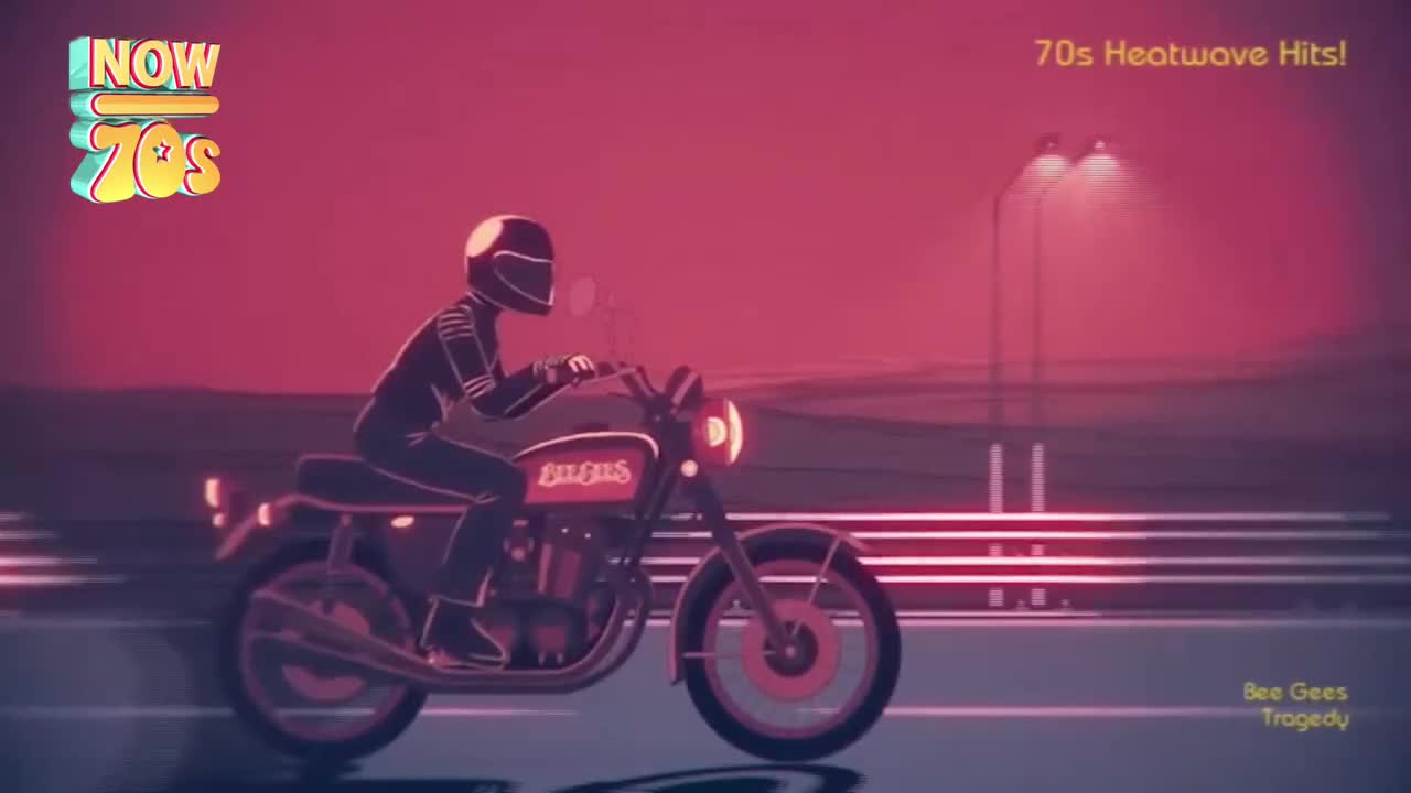 A motorcycle is cruising down a road, its headlight shining brightly. The rider, clad in black, is leaning into the turn, and the whole scene is bathed in a warm, reddish glow.
