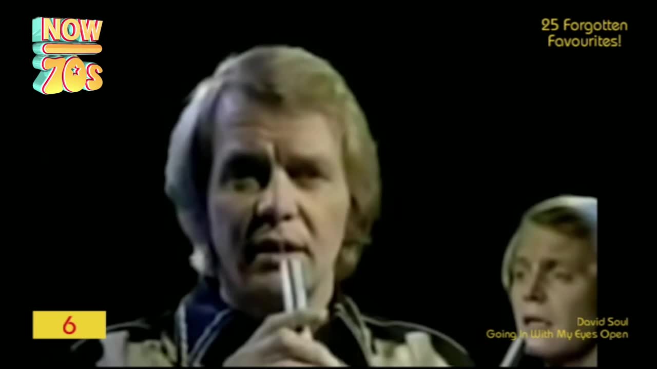 The singer, a man with blond hair, is holding a microphone and looking directly at the camera. A smaller image of him appears in the corner, and the "Now 70s" logo is visible in the top left.
