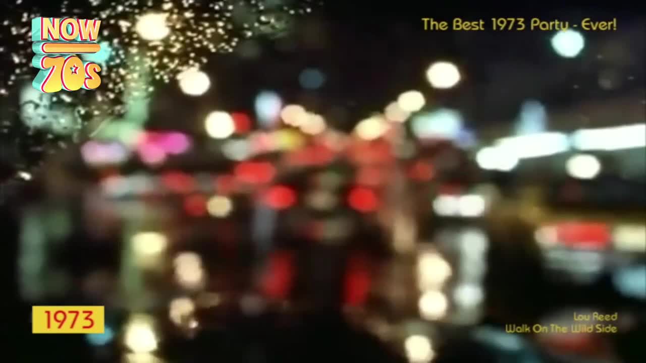Raindrops streak down the glass, blurring the neon lights of a city street. The red taillights of cars and the bright shop signs are softened into glowing orbs.
