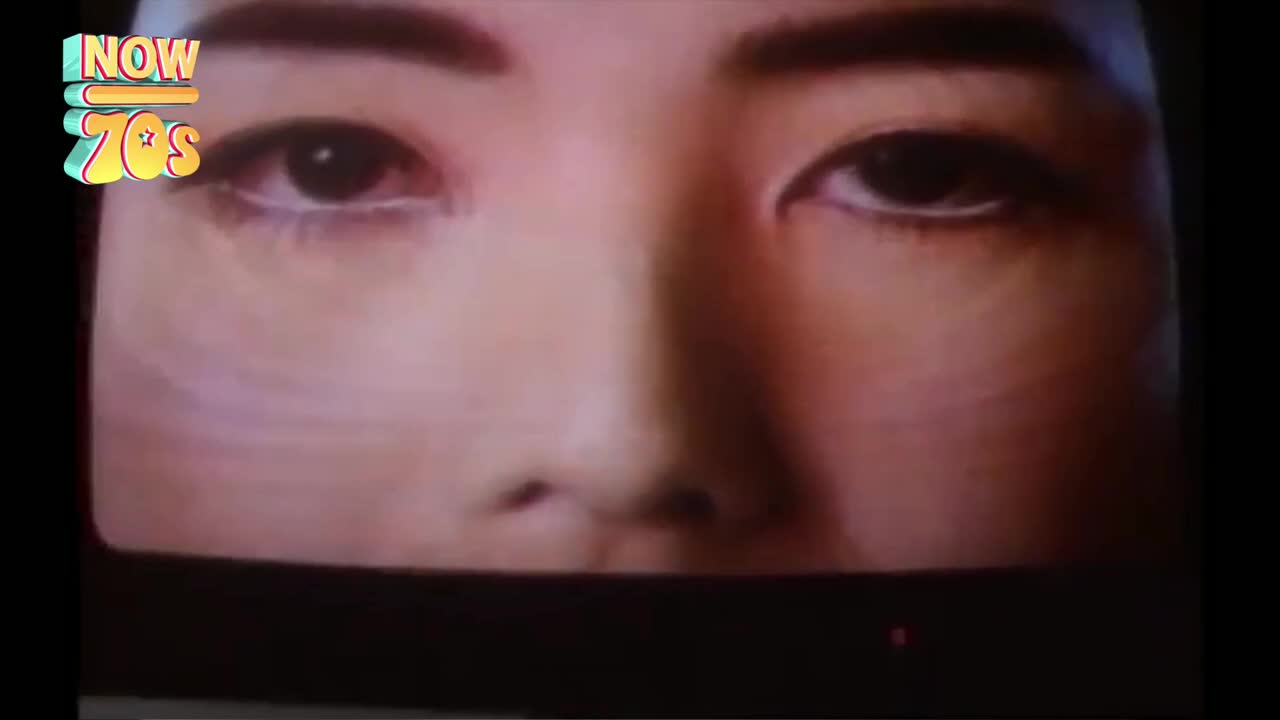 A close-up of a face, the eyes are open and looking directly at the viewer. The image is grainy, like it's from a television screen, maybe from the UK in the 70s.
A close-up of a face, the eyes are open and looking directly at the viewer. The image is grainy, like it's from a television screen, maybe from the UK in the 70s.