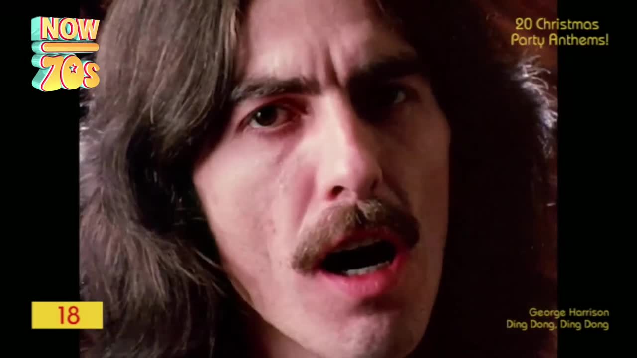 George Harrison, his mouth open, sings into the camera. His long hair frames his face, and a "NOW 70s" logo sits in the corner.
George Harrison, his mouth open, sings into the camera. His long hair frames his face, and a "NOW 70s" logo sits in the corner.