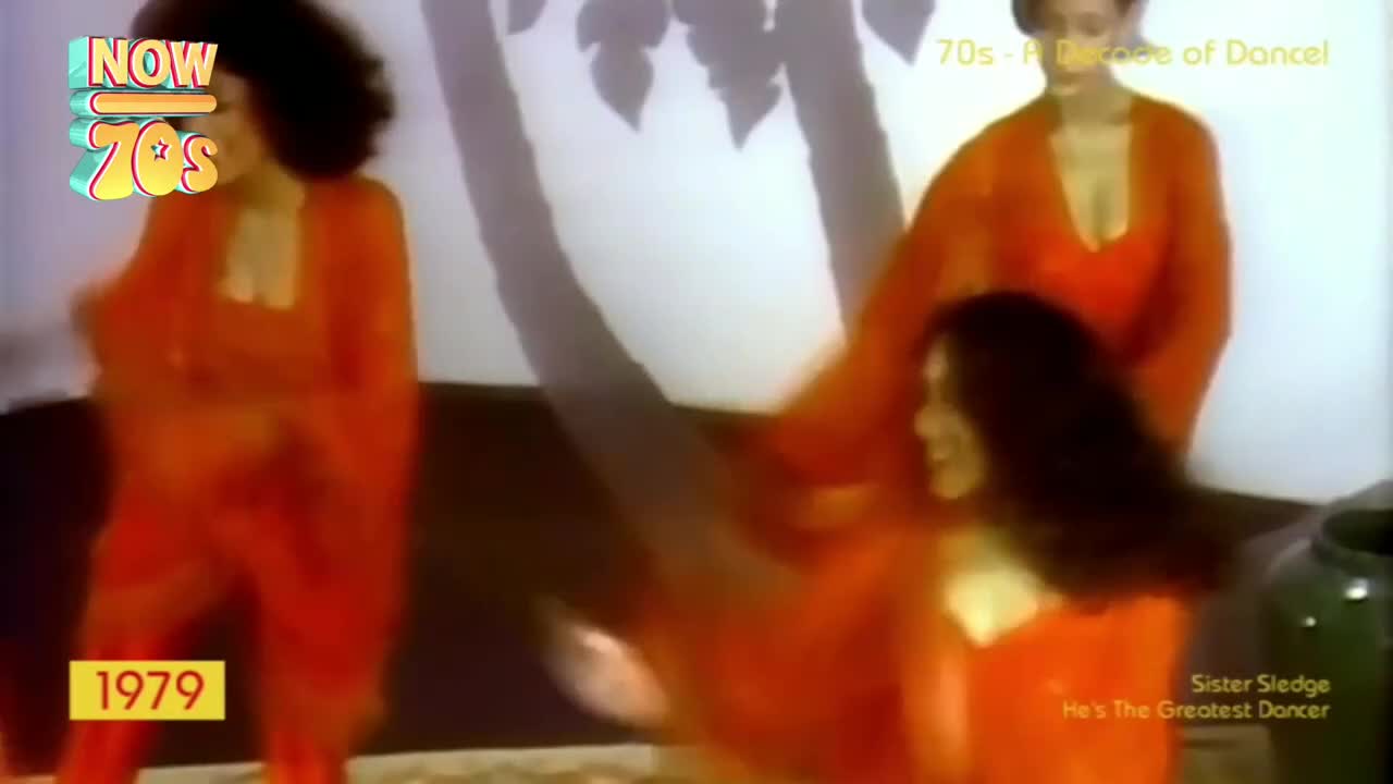 Three women in matching orange outfits are moving to the music, their arms and bodies flowing. The shadows of leaves dance behind them, adding to the rhythm.
Three women in matching orange outfits are moving to the music, their arms and bodies flowing. The shadows of leaves dance behind them, adding to the rhythm.