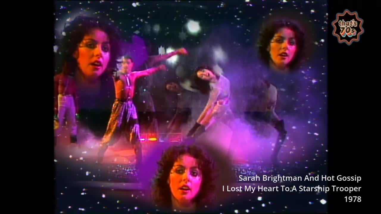 A woman in a sparkly dress spins on stage, her arms outstretched. Another woman, her face framed by dark curls, sings into a microphone, bathed in purple light.