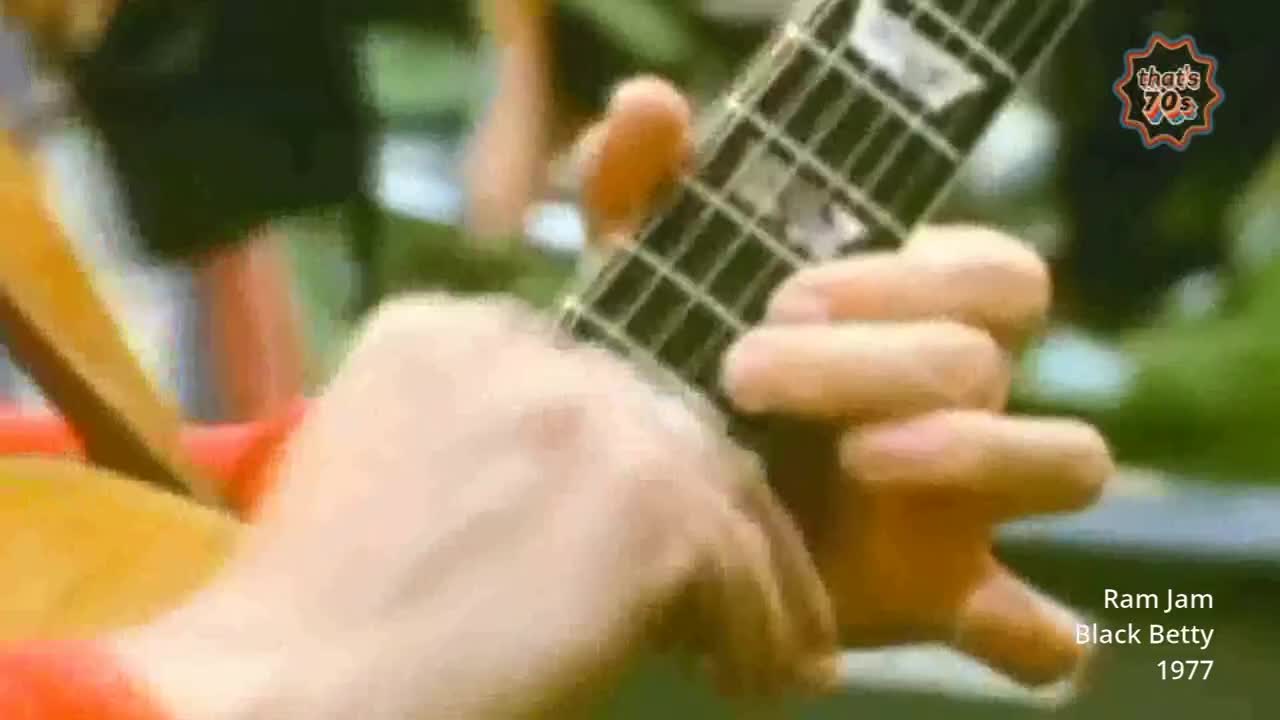 Fingers dance across the fretboard of a guitar, the instrument's wood gleaming. The sound of "Black Betty" fills the air, a familiar tune from the late seventies.