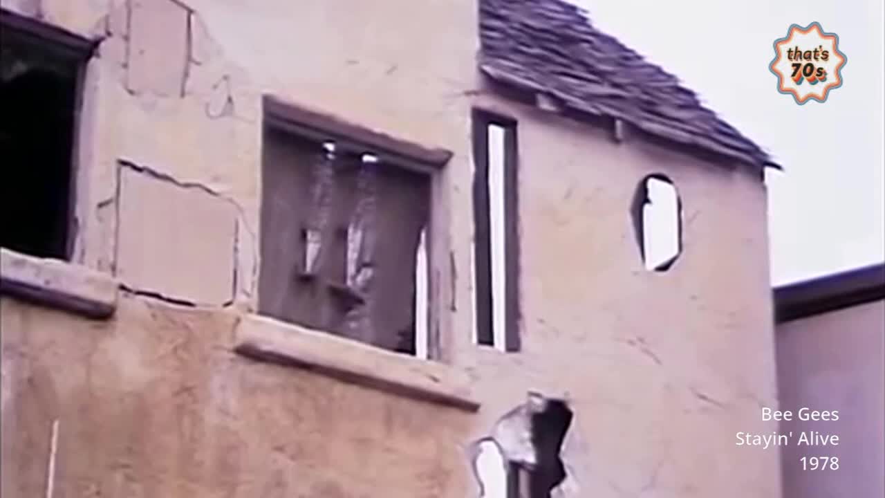 The crumbling facade of a building stands before me, its windows gaping voids. A slate roof slants precariously, hinting at years of neglect.