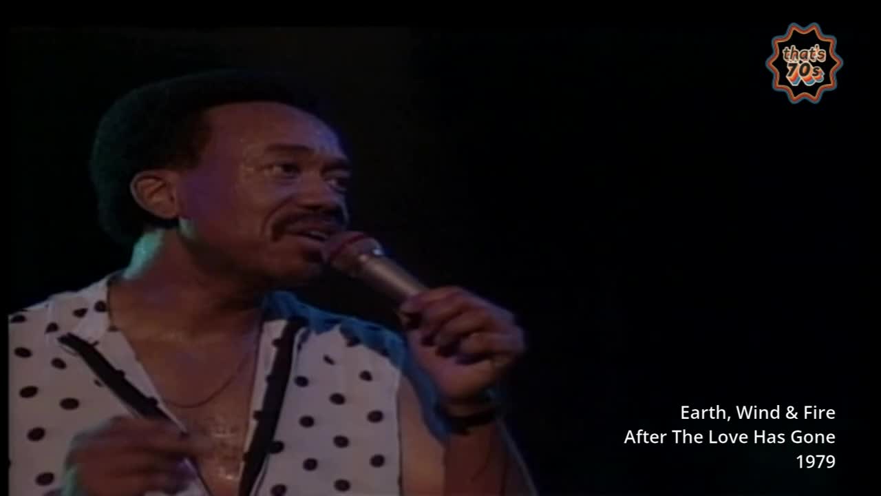 The singer grips the microphone, his polka-dot shirt catching the stage lights. He's mid-song, a familiar tune from 1979 filling the air.