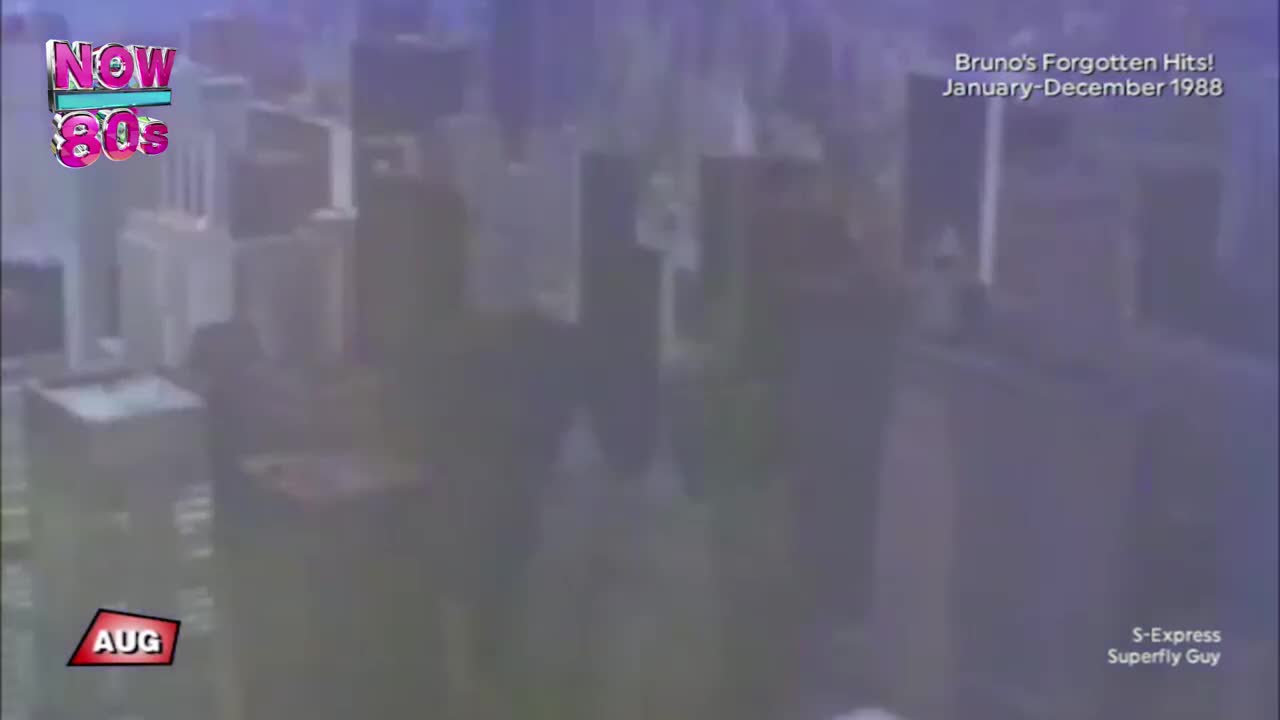 A hazy cityscape fills the screen, with tall buildings silhouetted against a purple hue. The "Now 80s" logo and the month of August are visible, along with a mention of Bruno's Forgotten Hits from 1988.
