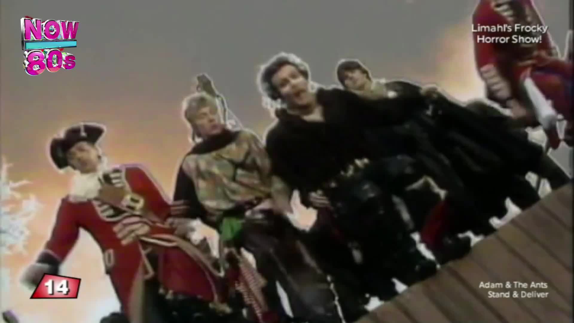The band, dressed in period costumes, are leaning forward as if riding something. The one in the red coat and tricorn hat is gesturing, while the others look like they're about to fall.
