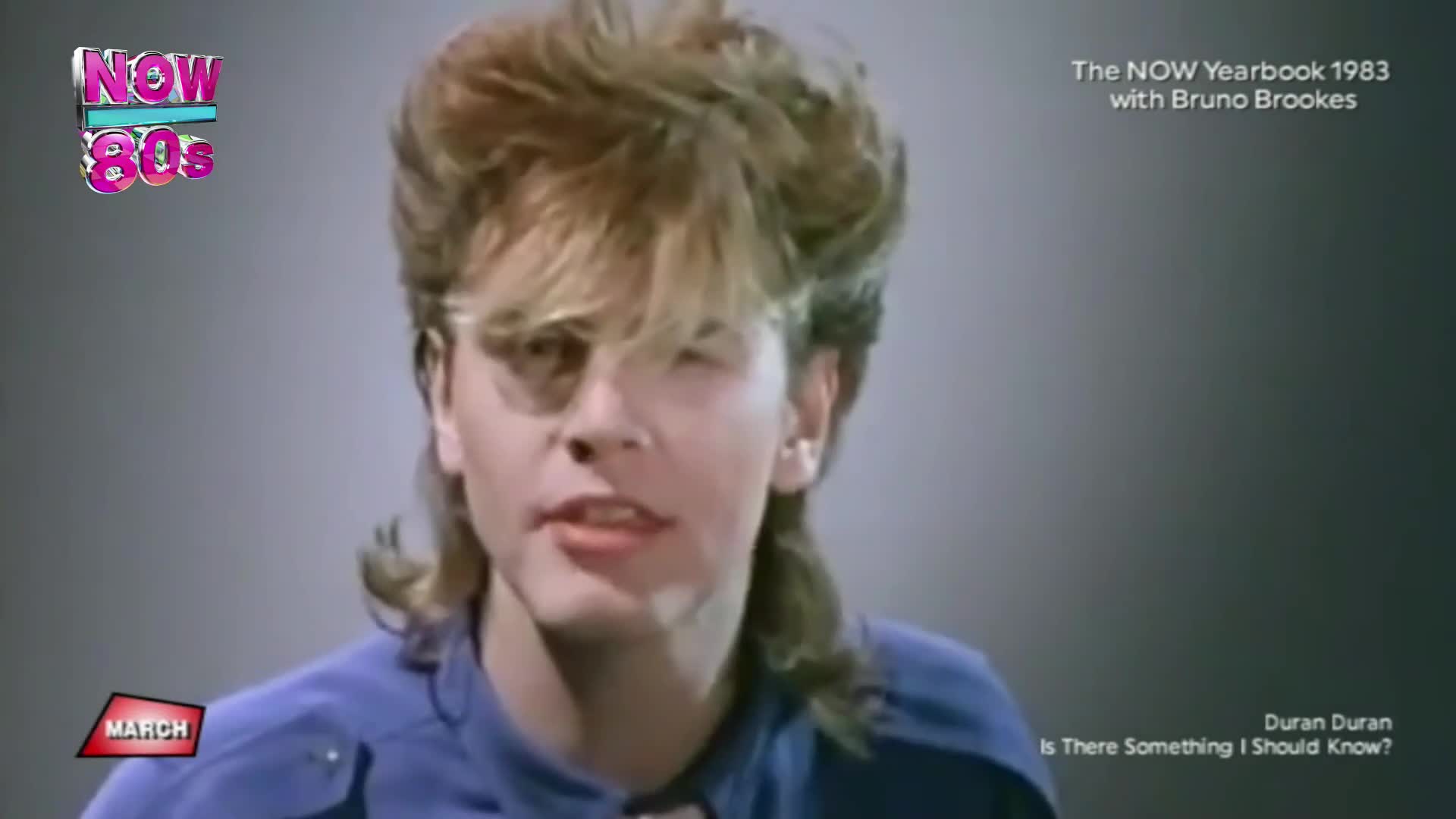 Simon Le Bon's distinctive hair bounces as he sings. The "NOW 80s" logo flashes in the corner, reminding me of the year 1983.