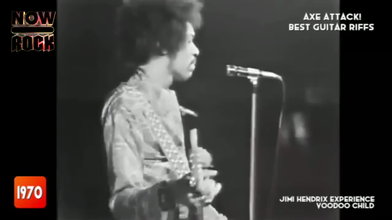 Jimi Hendrix, in a patterned shirt, stands angled toward the microphone, guitar in hand. He's about to launch into "Voodoo Child" on NOW Rock, 1970.
