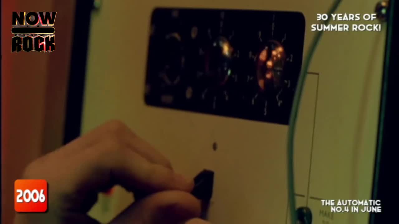 A hand is turning a black knob on a piece of equipment, likely in a recording studio. The glow of the tubes is visible behind the panel, and it's all for "NOW Rock" in the UK.
