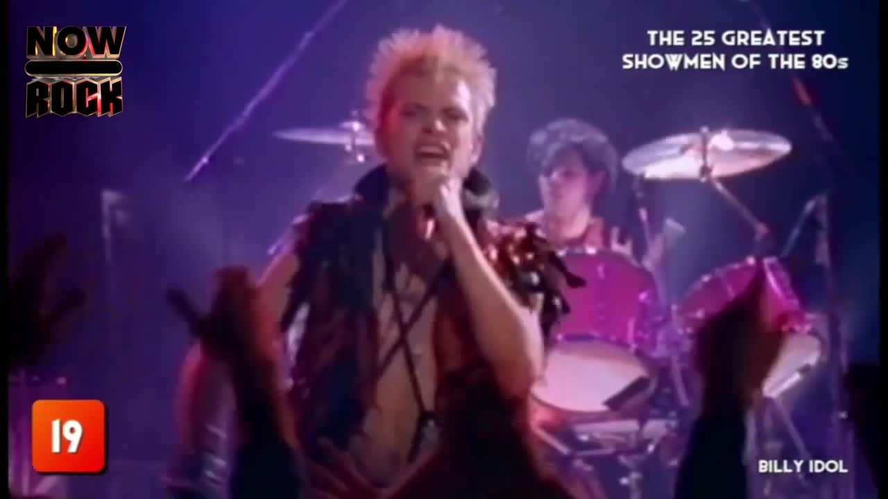 Billy Idol, mic in hand, sings with a wild energy, his spiky blonde hair catching the stage lights. Behind him, a drummer keeps the beat, and the crowd's hands reach toward the stage.
