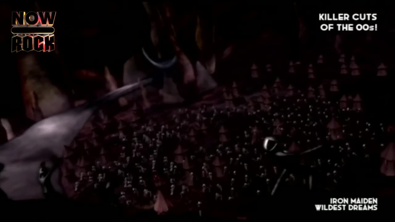 A mass of tiny figures is scattered across a dark landscape, some of them silhouetted against the gloom. Above them, a curved, metallic object cuts through the air.
