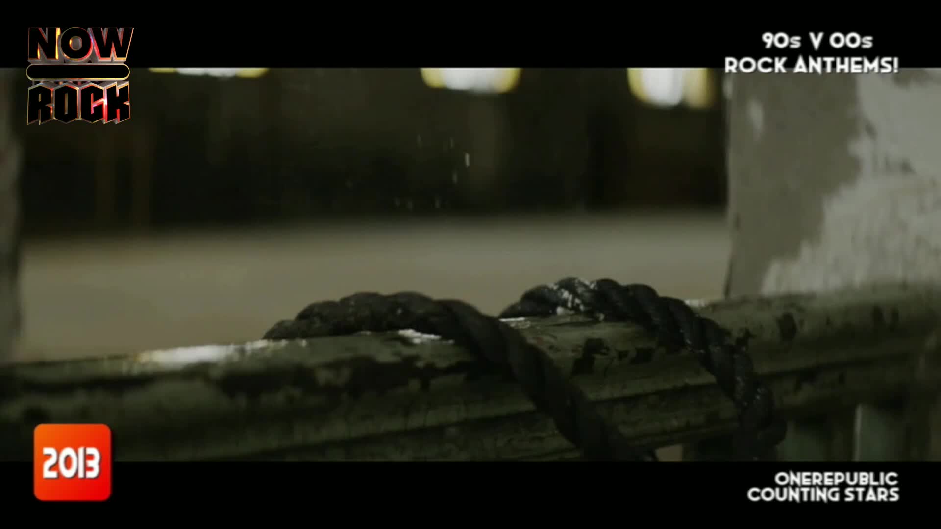 A thick, dark rope is coiled over a weathered rail. Above, a few droplets of water fall, catching the light in the dim, industrial space.
A thick, dark rope is coiled over a weathered rail. Above, a few droplets of water fall, catching the light in the dim, industrial space.