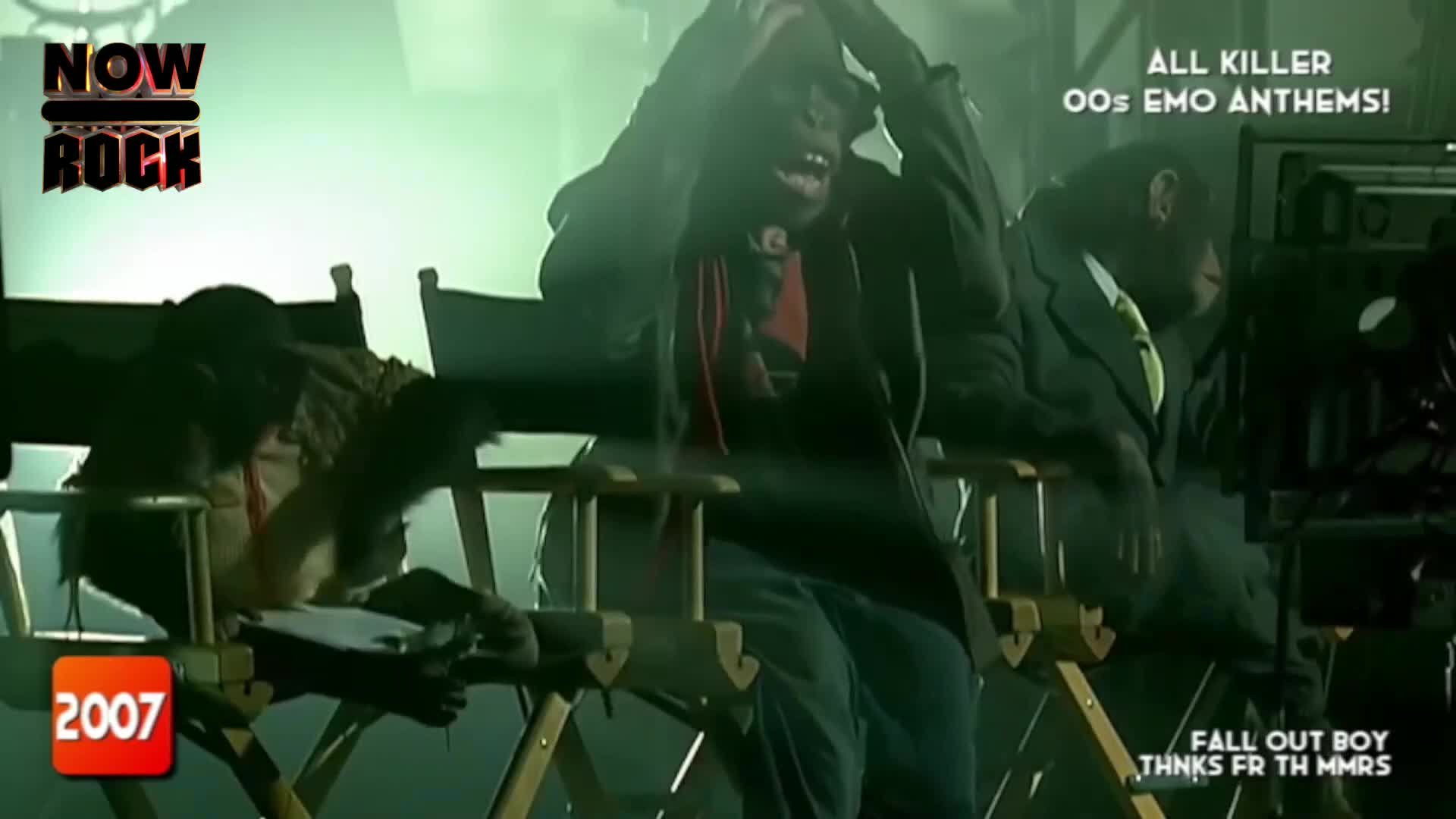 A chimpanzee in a hoodie clutches its head, looking distressed. Another chimpanzee, dressed in a suit, sits beside it, appearing somewhat resigned. A chimpanzee in a hoodie clutches its head, looking distressed. Another chimpanzee, dressed in a suit, sits beside it, appearing somewhat resigned.