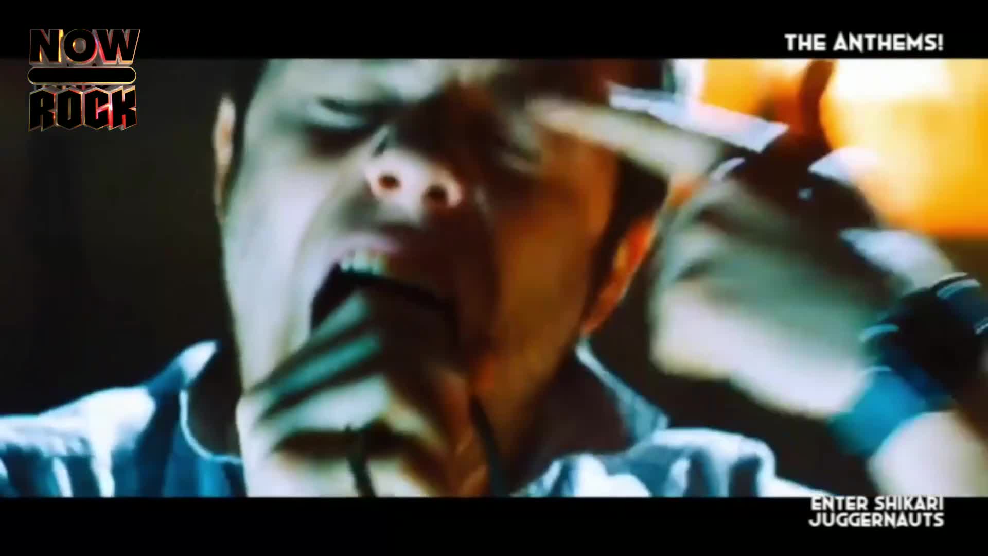 The singer's face is contorted in a raw scream, his hand reaching up to his forehead. This is Enter Shikari, live and loud on Now Rock.