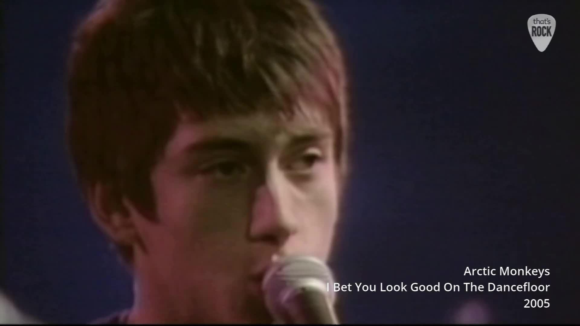 The singer leans into the microphone, his dark hair falling forward. The stage lights cast a warm glow on his face as he sings. The singer leans into the microphone, his dark hair falling forward. The stage lights cast a warm glow on his face as he sings.