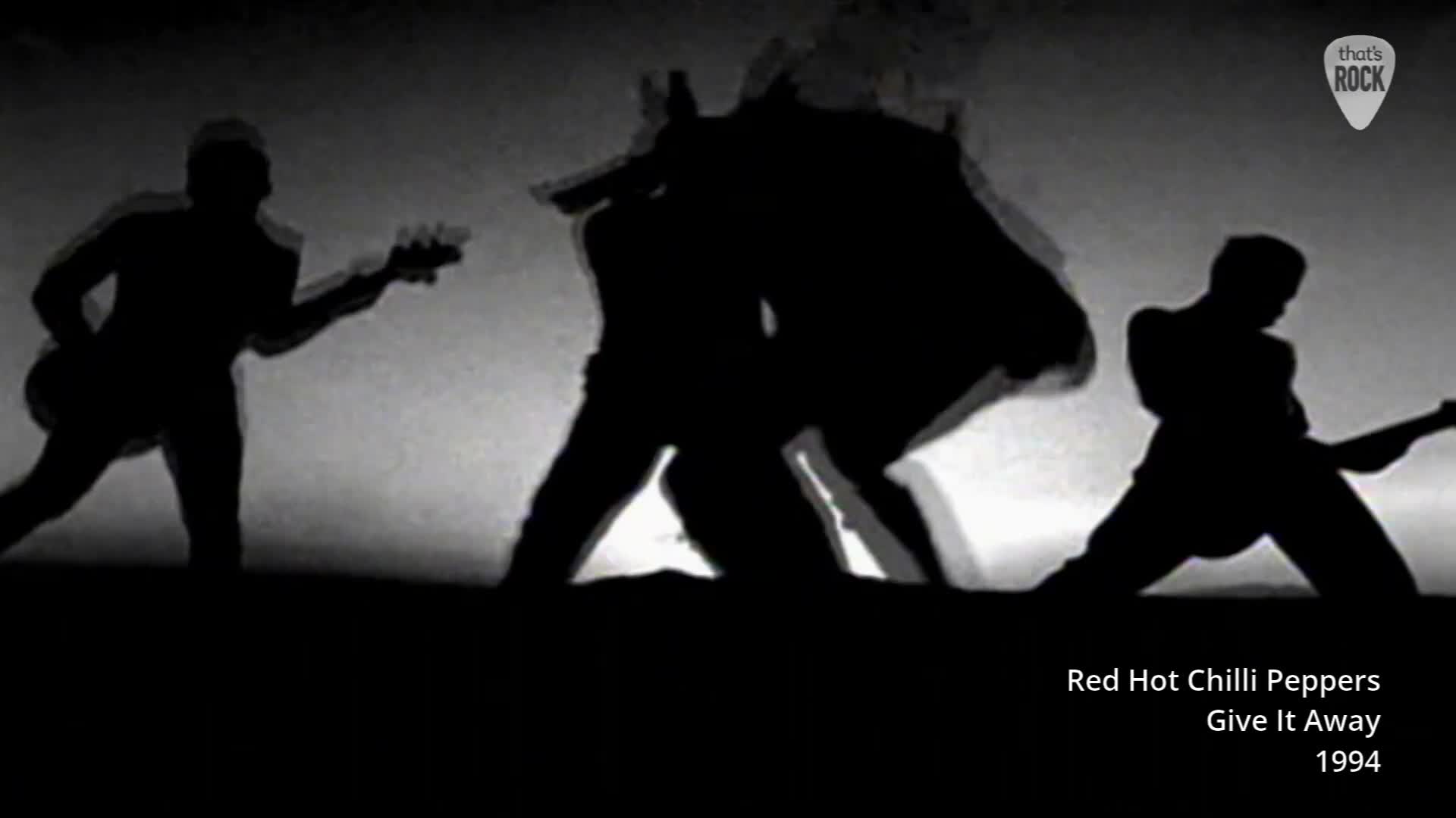 Silhouetted figures thrash and leap across the stage, their guitars held aloft. The lead singer is a whirlwind of motion, a stark contrast to the steady rhythm of the bass player.