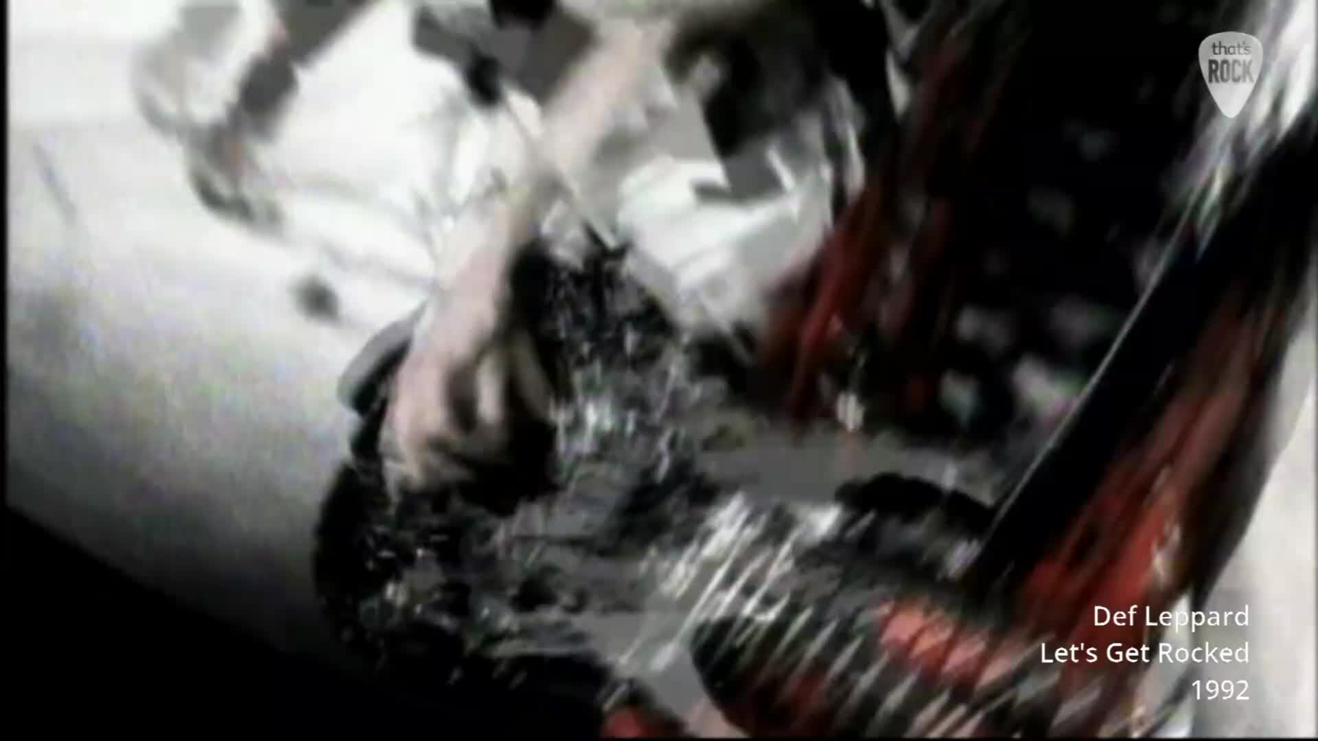 A hand grips a microphone stand, its knuckles white. The stage lights catch the glint of sweat on a singer's face as he leans into the mic.