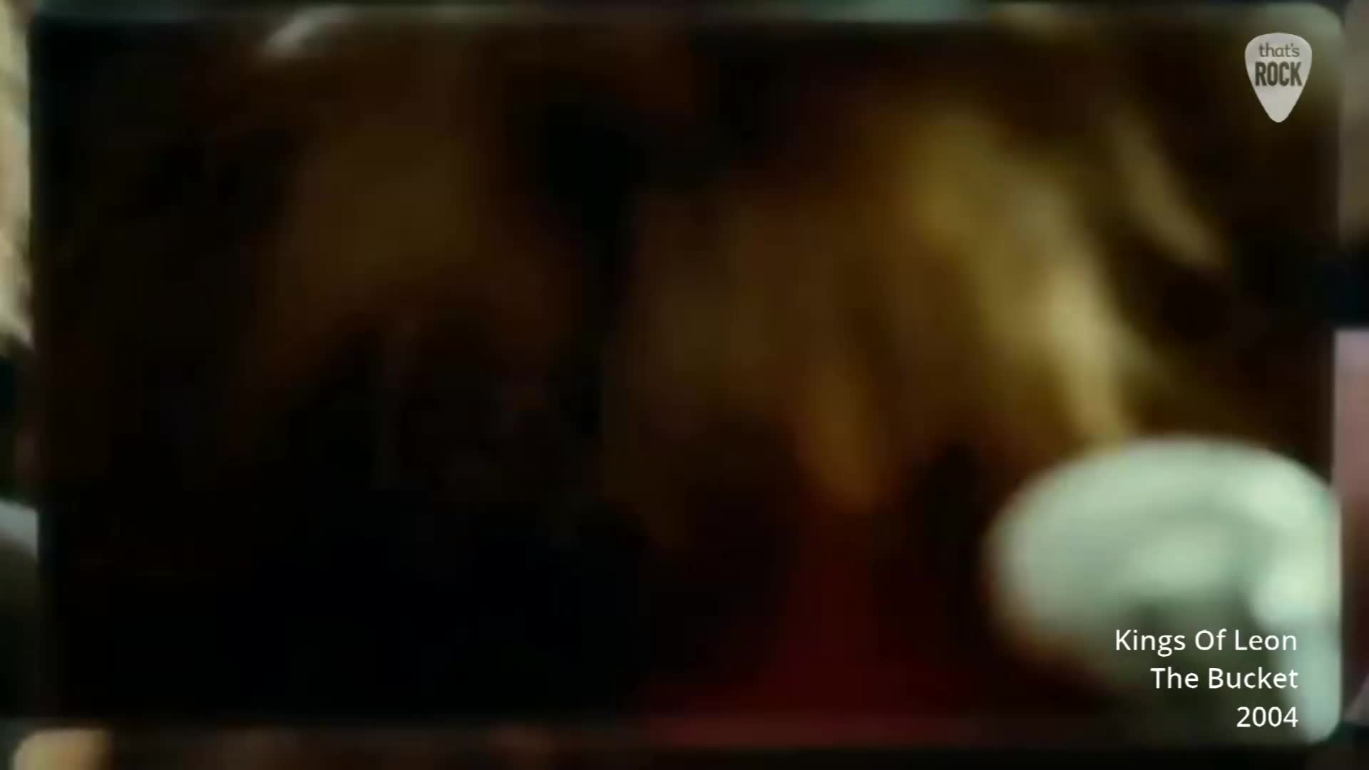 A fuzzy, warm light washes over the scene, illuminating indistinct figures. A white, rounded object sits in the foreground, catching the light. A fuzzy, warm light washes over the scene, illuminating indistinct figures. A white, rounded object sits in the foreground, catching the light.