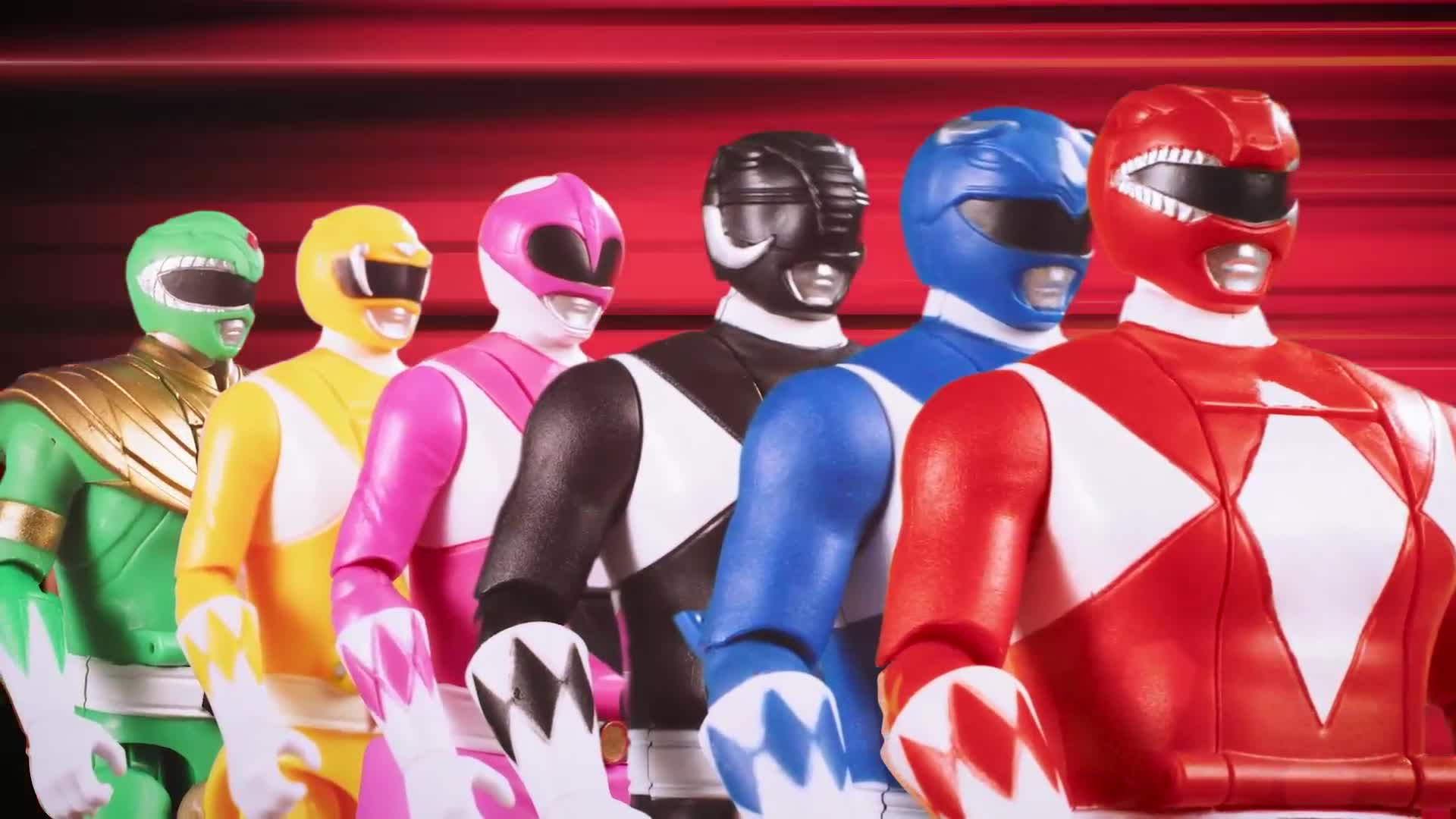 Six brightly colored figures in matching helmets and suits stand shoulder to shoulder. The Red Ranger is in the front, and the others are lined up behind him in a rainbow of hues.
