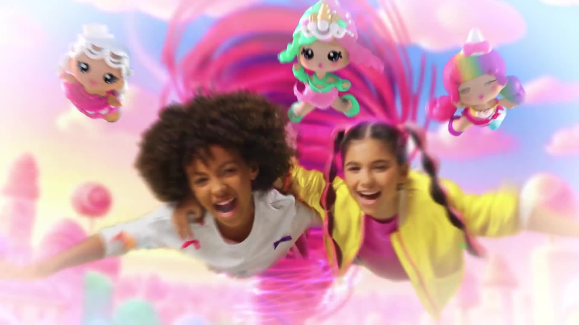 The two kids are grinning and reaching out, while miniature, candy-colored figures float around them. A swirling, pink and purple backdrop completes the scene.
