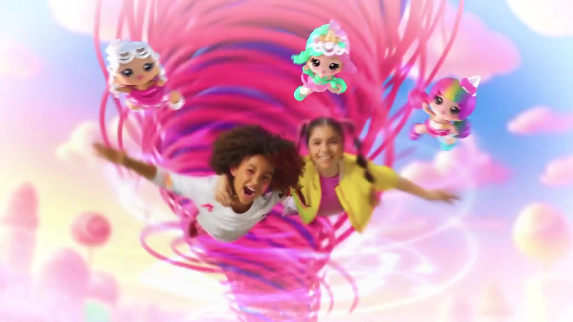 Two girls are suspended in the air, their arms outstretched, as small, doll-like figures float around them. A swirling pink and purple vortex dominates the backdrop, adding to the whimsical feel.
