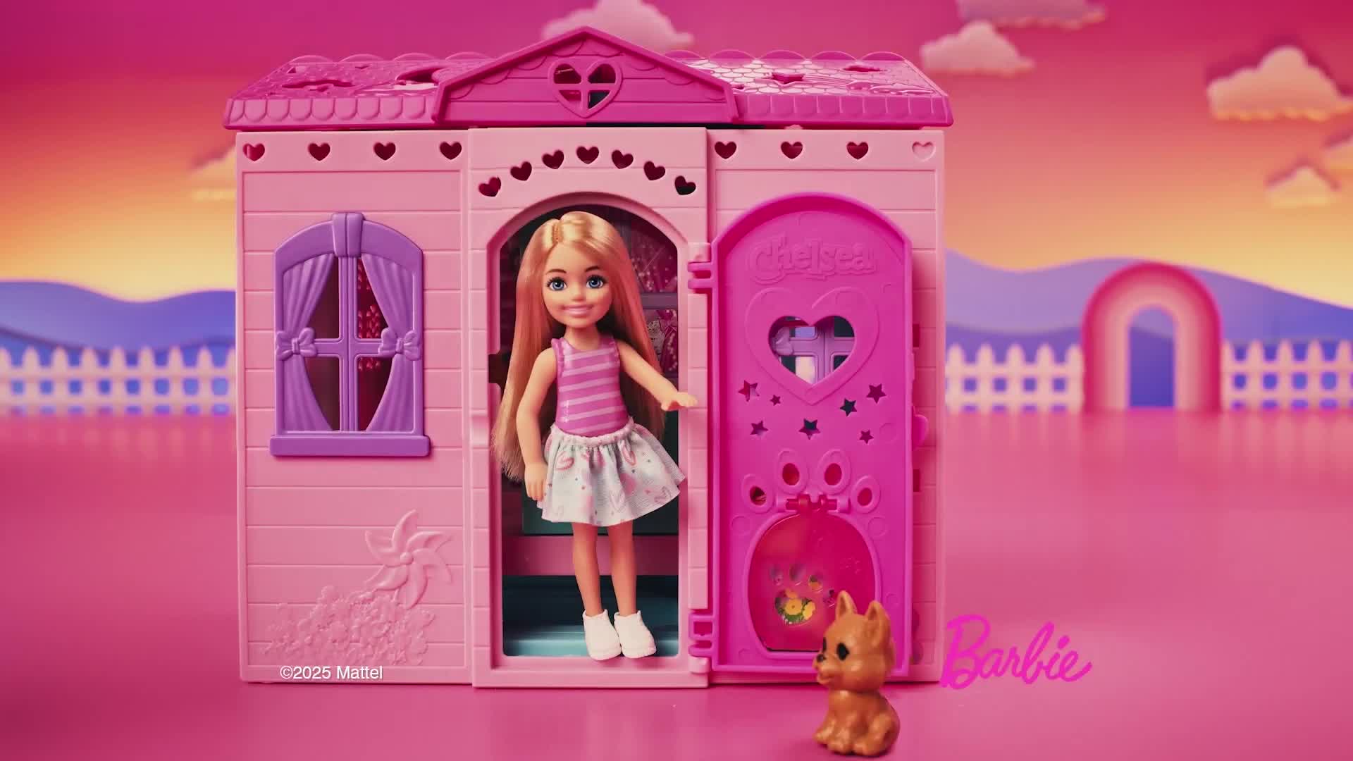 A dollhouse, painted in shades of pink, stands center stage, with a blonde doll smiling in the doorway. A small, brown puppy sits patiently at the door's base.
