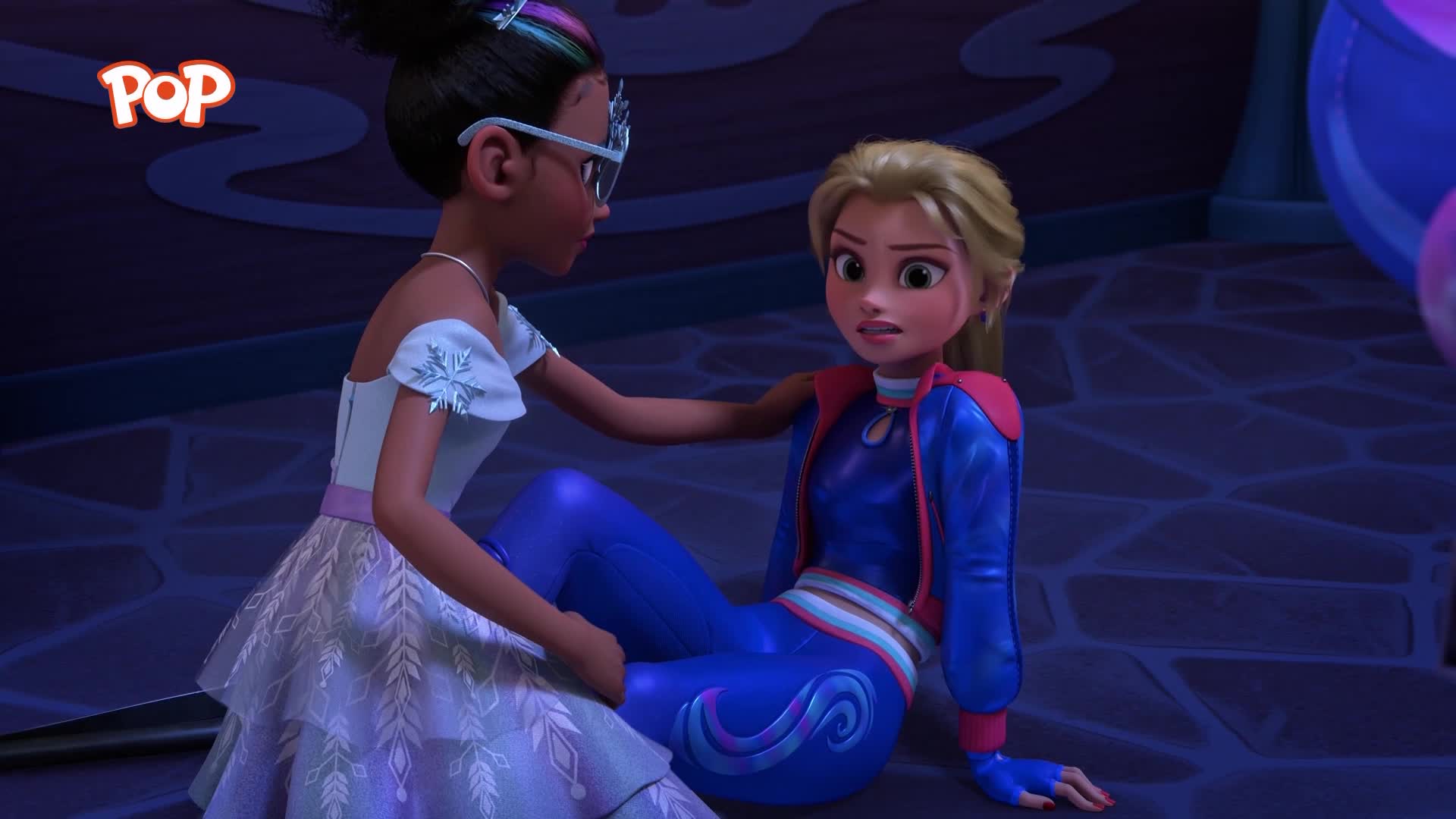 A girl in a sparkly dress reaches out to comfort another girl who's sitting on the floor in a blue and red tracksuit. The Pop logo is visible in the top left corner.