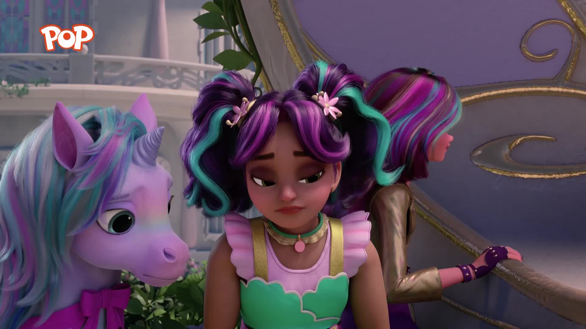 A purple unicorn with a rainbow mane looks down, its expression worried. Beside it, a girl with colourful pigtails gazes sadly into the distance, her shoulders slumped.