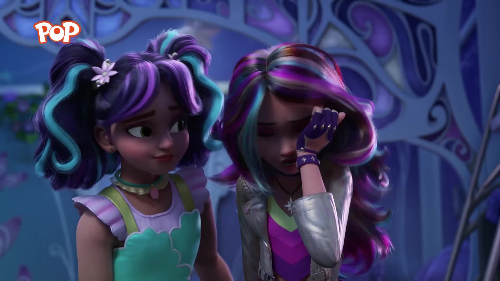 One girl, with vibrant purple and blue streaks in her hair, reaches up to wipe away a tear. Her friend, sporting similar colourful hair in pigtails, looks on with concern.