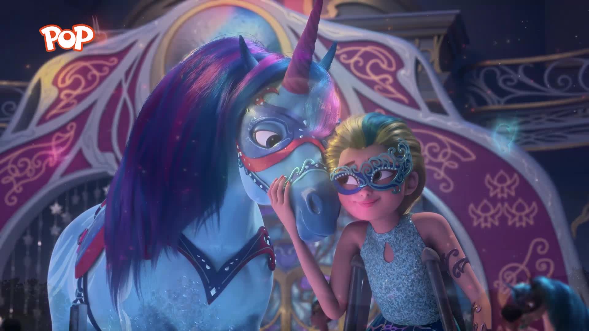 A girl in a sparkly blue dress and mask gently strokes a blue unicorn's face, its mane a mix of vibrant purple and pink. The unicorn, also masked, leans in, its large eyes looking towards the girl.