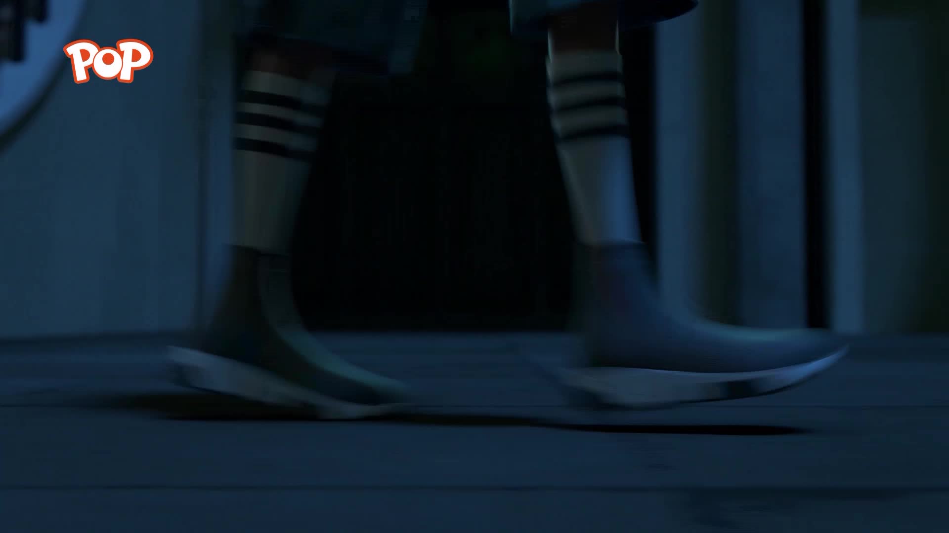 A pair of feet in light grey trainers with white soles and striped socks hurry across a wooden floor. The POP logo flashes in the corner.