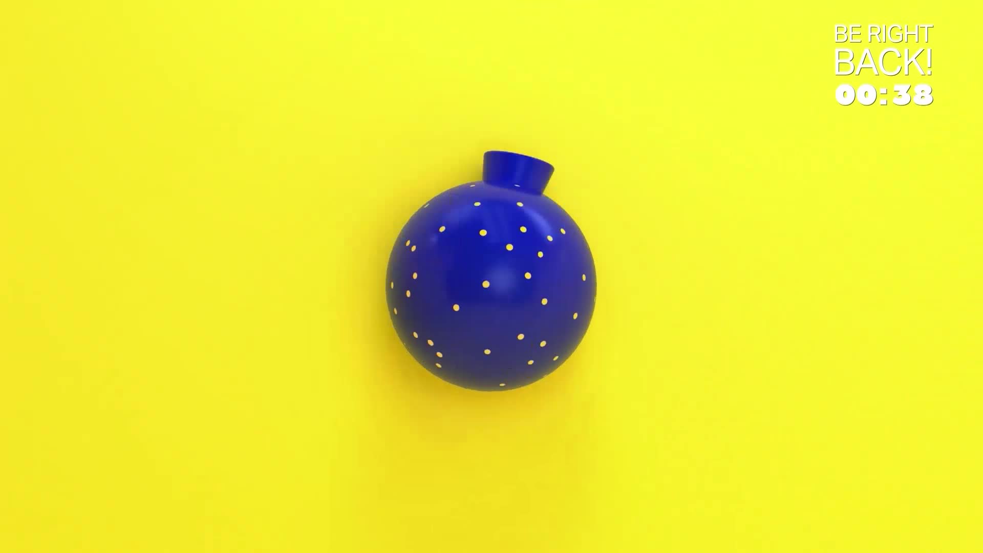 A bright blue bauble, dotted with tiny yellow spots, hangs suspended against a vibrant yellow background. A digital timer in the corner counts down from 38 seconds.