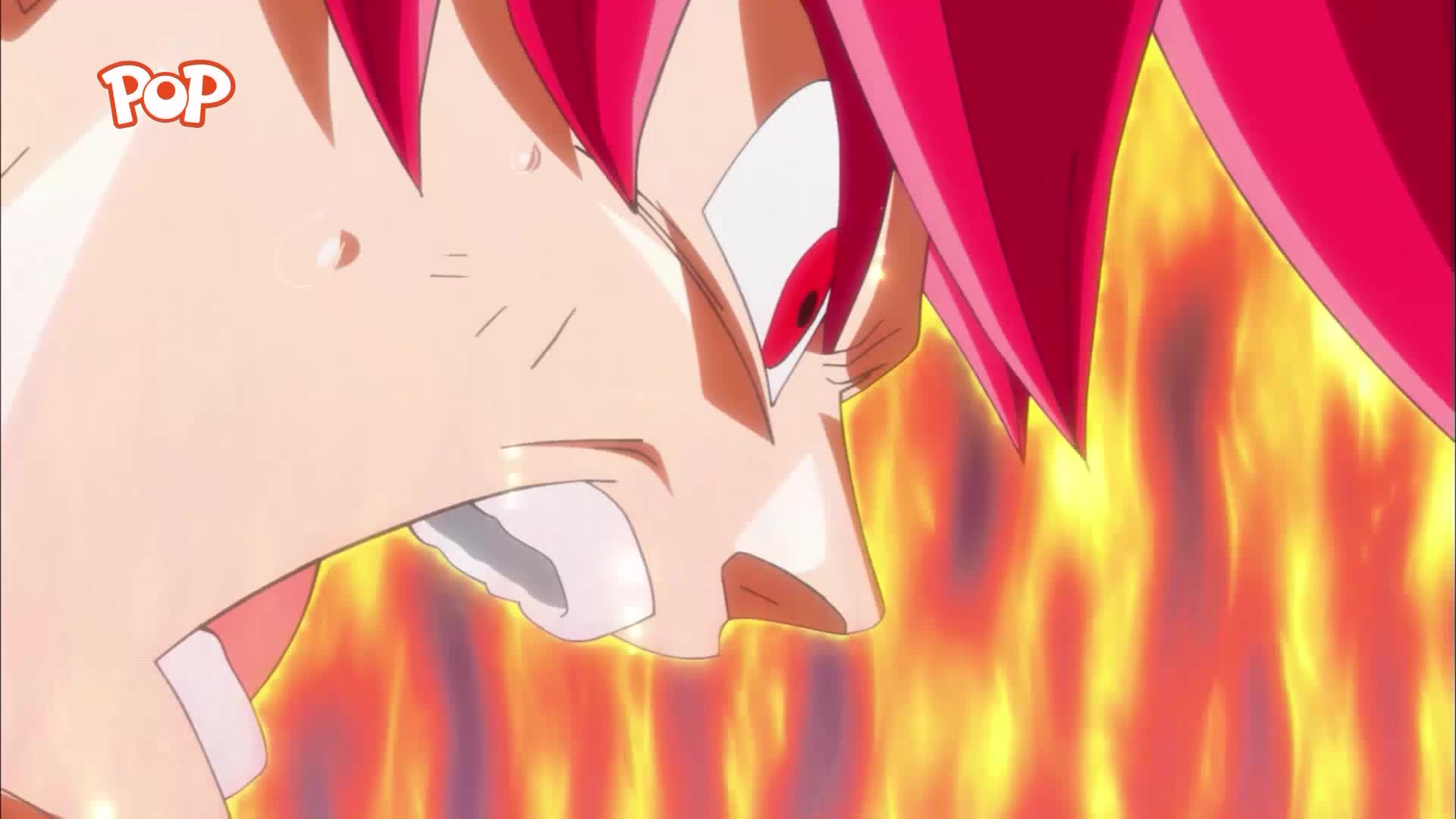 A man's face, contorted in a fierce expression, is engulfed in a vibrant, fiery aura. His spiky red hair seems to crackle with energy, mirroring the intense orange and yellow flames that surround him.