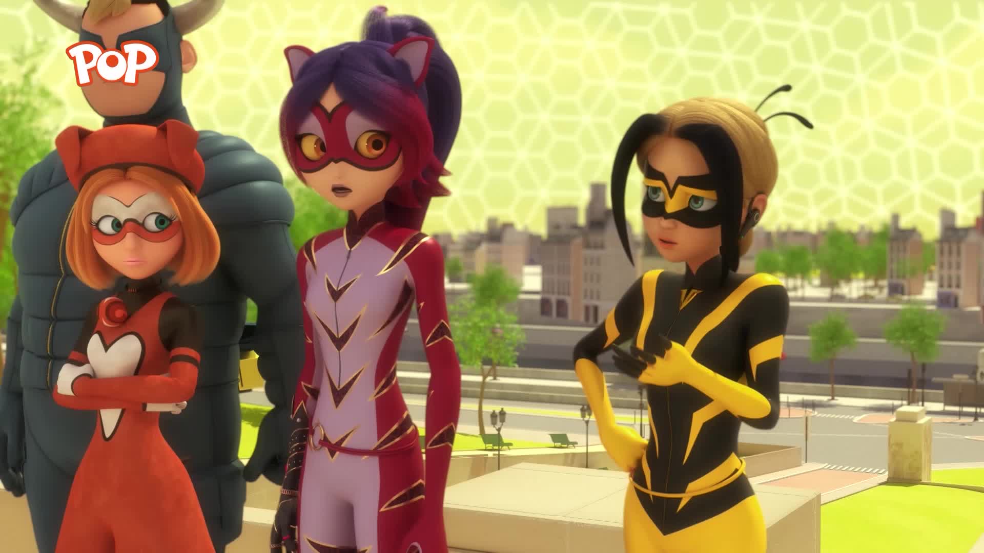 A group of four figures in brightly coloured costumes stand on a rooftop overlooking a city. The one on the far left wears a bull mask and horns, while the others sport animal-themed outfits.