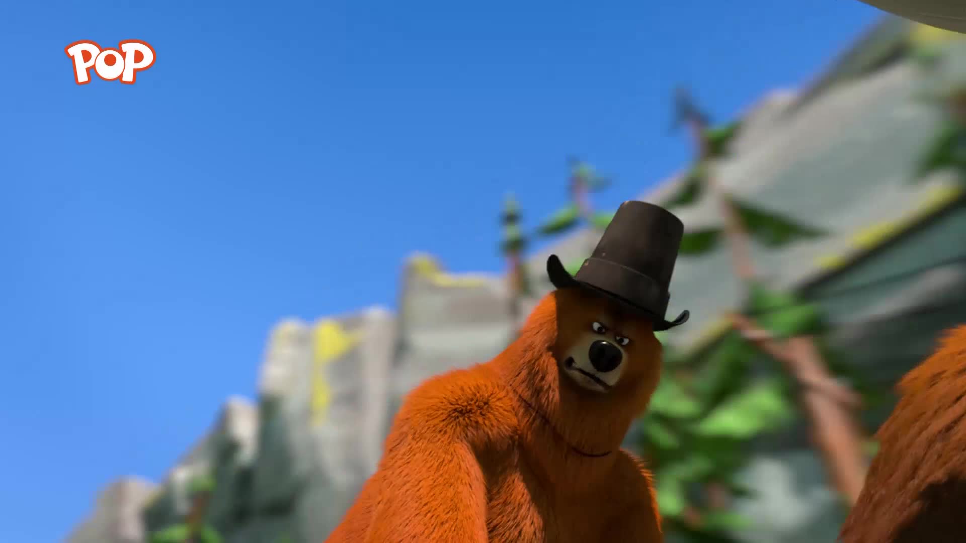A furry brown bear wearing a tall black hat turns its head, its brow furrowed. The bright blue sky above is clear, with a small "POP" logo in the corner. A furry brown bear wearing a tall black hat turns its head, its brow furrowed. The bright blue sky above is clear, with a small "POP" logo in the corner.