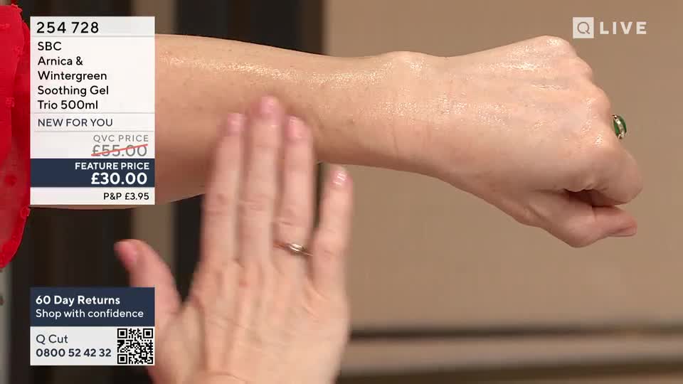 A hand is gently smoothing a gel onto an arm, its fingers gliding over the skin. The arm glistens, catching the light as the product is worked in.
