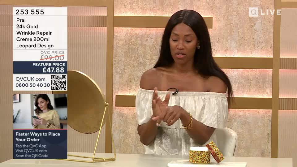 A woman in a white off-the-shoulder top rubs cream into her hands, demonstrating the product. Beside her, a small leopard-print jar and box sit on the table.
