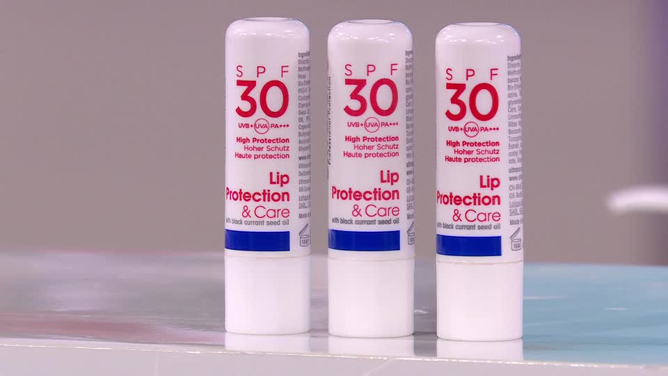 Three white lip balm tubes, each with a bold SPF 30 label, stand side-by-side.  The packaging promises lip protection and care.
