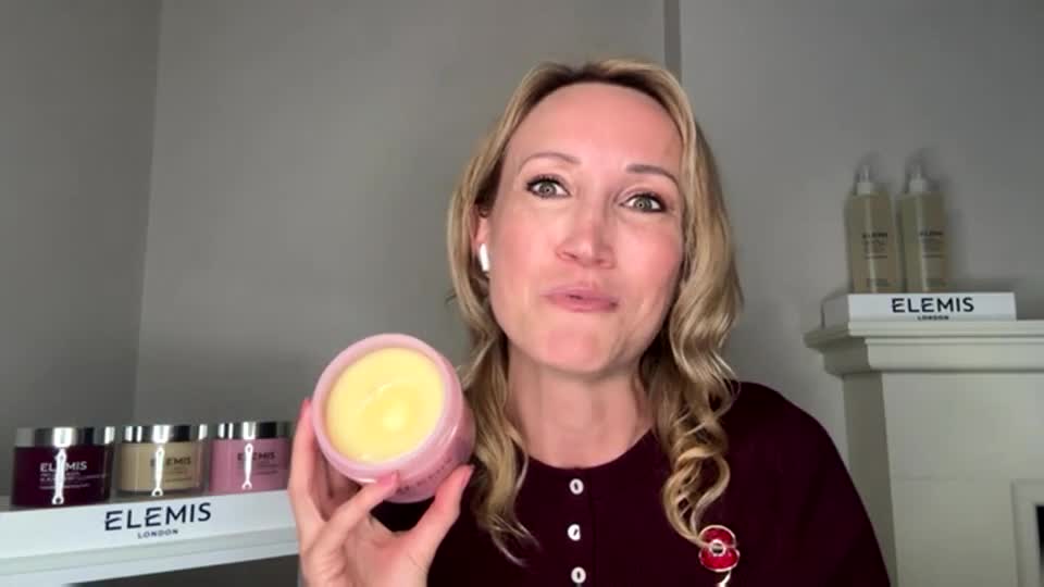 A woman in a burgundy top holds up a jar of creamy, yellow product, likely for a QVC Beauty segment. She's talking, and the camera is close, focused on her and the product.
A woman in a burgundy top holds up a jar of creamy, yellow product, likely for a QVC Beauty segment. She's talking, and the camera is close, focused on her and the product.