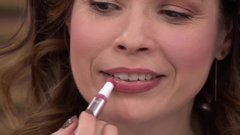 A woman in the United Kingdom is applying lip gloss, her lips already coated in a glossy pink. She smiles as she carefully glides the applicator across her bottom lip.
A woman in the United Kingdom is applying lip gloss, her lips already coated in a glossy pink. She smiles as she carefully glides the applicator across her bottom lip.