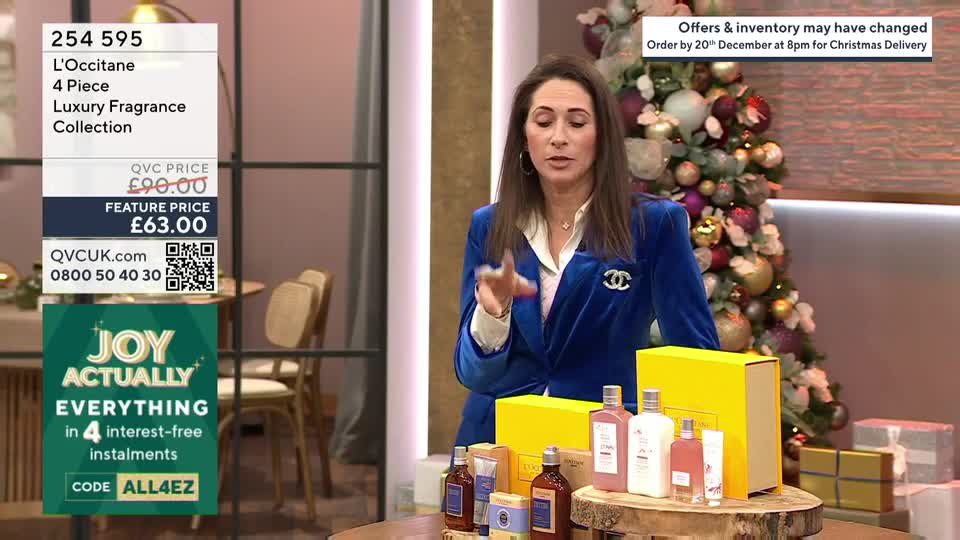 A woman in a blue velvet jacket gestures towards a selection of L'Occitane fragrance products on a table. Behind her, a Christmas tree shimmers, and a graphic advertises interest-free installments on QVC UK.
A woman in a blue velvet jacket gestures towards a selection of L'Occitane fragrance products on a table. Behind her, a Christmas tree shimmers, and a graphic advertises interest-free installments on QVC UK.
